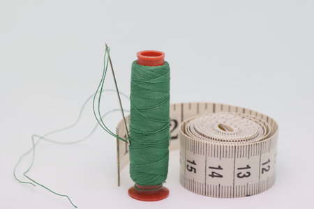 sewing threads and materials cut off on a white background