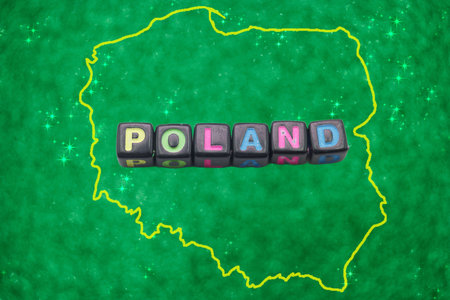 Colorful letters spell out Poland, positioned prominently against a vibrant green background that features the outline of the country. The focus is on national identity and pride.の写真素材