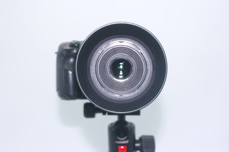 A camera lens is positioned prominently, highlighting its intricate design. The setting is indoors, ideal for capturing vivid details and textures, emphasizing the art of photography.の写真素材
