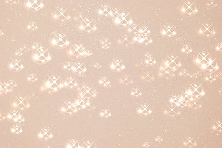 Delicate sparkles and reflections fill the soft pastel background with a magical glow. The luminous scene evokes a sense of wonder, elegance, and beauty, perfect for celebration.の写真素材