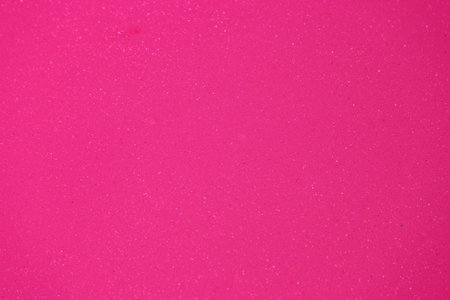 A vibrant, sparkly pink surface provides a playful backdrop for arts and crafts activities. This vividly color inspires creativity and fun during various projects at home.の写真素材