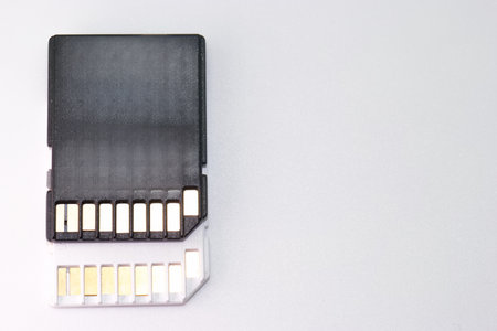Close up of a memory card showing its sleek design and metal connection pins, emphasizing its...