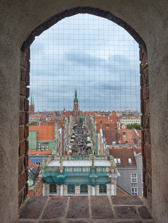 The vibrant rooftops of a city, emphasizing the intricate detailing of buildings and church steeples...