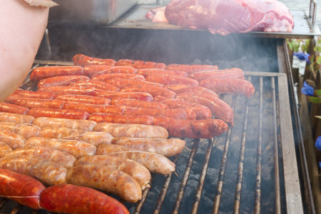 Savory sausages sizzle on the grill, surrounded by smoke and the aroma of cooking meat. This lively...
