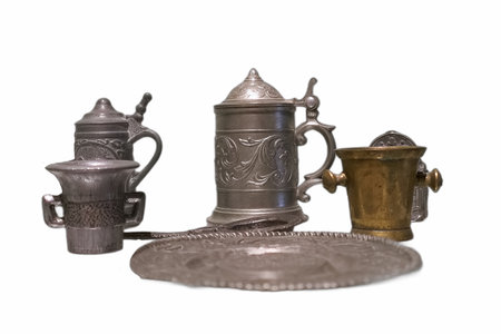 A collection of beautifully crafted metal drinkware is arranged on a clean surface.の写真素材