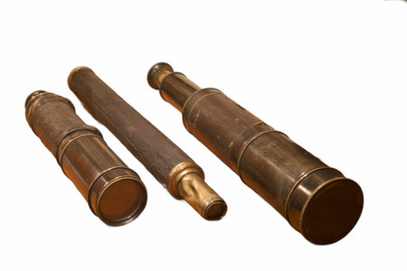 Three brass telescopes are arranged neatly on a white surface, highlighting the intricate design and...