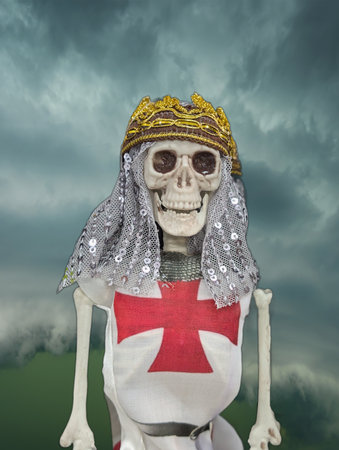 A skeleton figure stands proudly in a medieval knight costume featuring a red cross. The figure wears a decorative crown and veil, surrounded by a dramatic cloudy backdrop.の写真素材