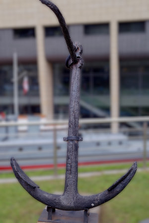 This historic anchor is displayed at a waterfront location, capturing the essence of maritime...