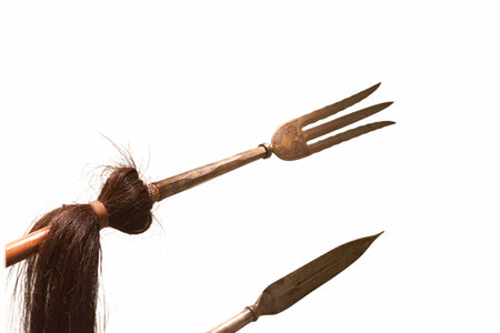 This artwork presents two traditional tools, featuring a fork with three prongs and a sharp blade....