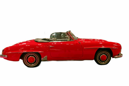 This red convertible showcases a classic design with a soft top. It is positioned prominently...