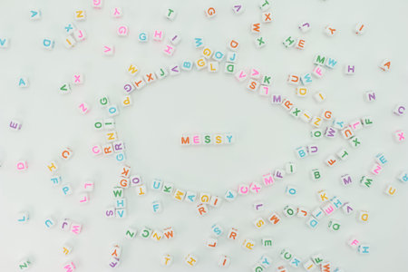 Colorful plastic letters are spread across a flat surface. In the center, letters form the word...