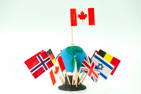 Colorful flags from Canada, Norway, Israel, the UK, and other countries surround a handmade globe....