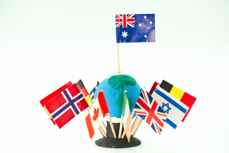 Different country flags are attached to a globe model in a classroom setting. Students are likely to...