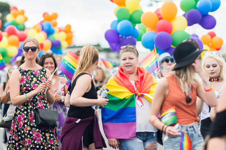 STOCKHOLM, SWEDEN â JULY 30, 2016: Women holding rainbow flags and balloons during Stockholm Pride Parade on Hantverkargatan near the City Hallのeditorial素材