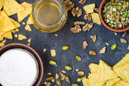 Ingredients layout for baking soft cheese brie with walnuts, pistachios and honey. Snack concept...