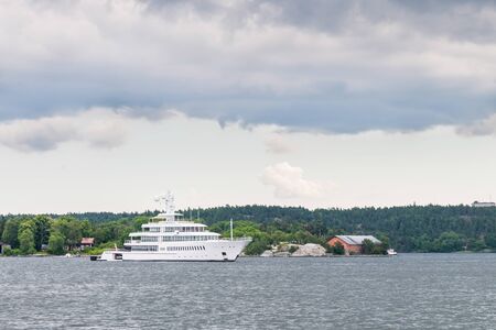 View over boats sailing in Baltic sea in Stockholm, Sweden, with the city in the backgroundの写真素材