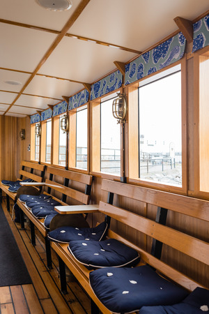 STOCKHOLM, SWEDEN - JULY 12, 2017: Boat interior with windows, wooden benches and soft seatsのeditorial素材