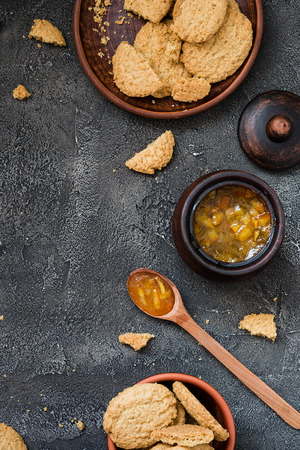 Cookies and orange jam on dark background, copy space. Dessert conceptの写真素材