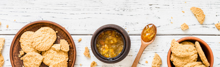 Cookies with orange jam on white wooden background. Dessert concept