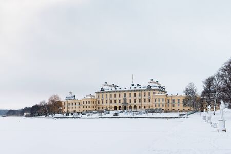 STOCKHOLM, SWEDEN - JANUARY 7, 2017: View over Drottningholm Palace and lake on a winter day. Home...
