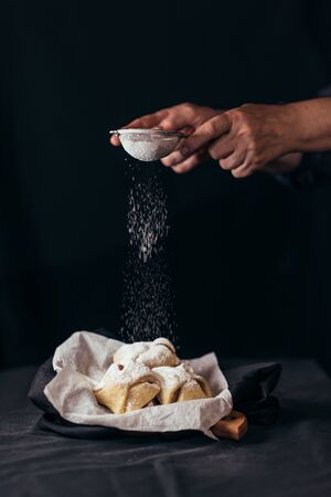 Decorating gingerbread cookies with powdered sugarの写真素材