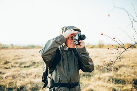 Man photojournalist poses with his photo camera.の写真素材