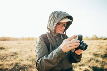 Man photojournalist poses with his photo camera.の写真素材