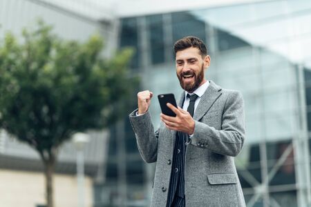 Dance success. Successful confident businessman celebrates his success. Young man formal wear his...