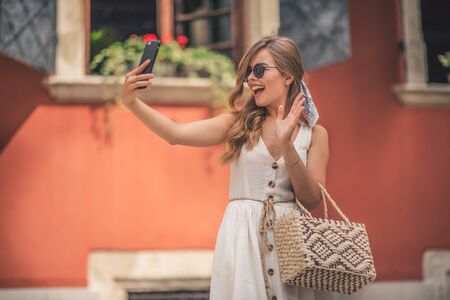 Selfie of funny attractive girl pouting and showing v-sign.の写真素材