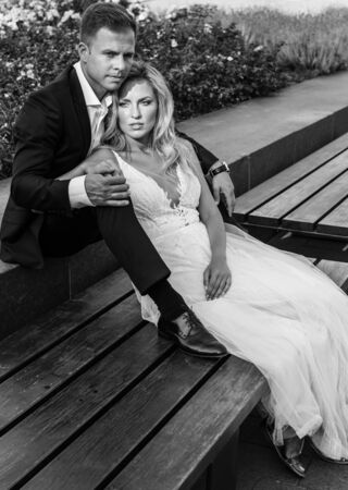 Bride and groom hugging in the old town street. Wedding couple in love. Luxury rhinestone dress.の写真素材