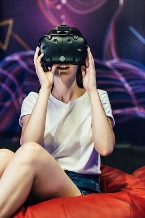 Woman wearing VR goggles. She is fascinated about what she sees.の写真素材