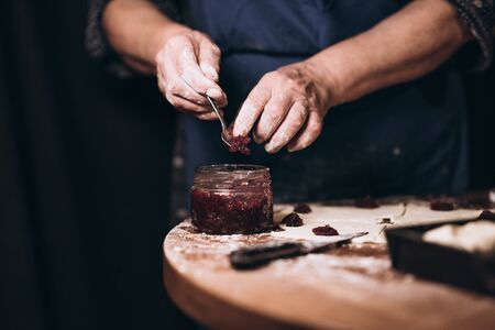 Housewife roll pieces of dough with plum jamの写真素材