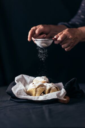 Decorating gingerbread cookies with powdered sugarの写真素材