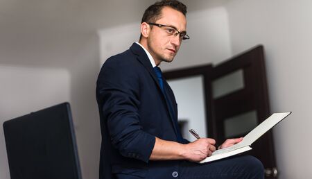 Businessman working, businessman in office, businessman looking at documents