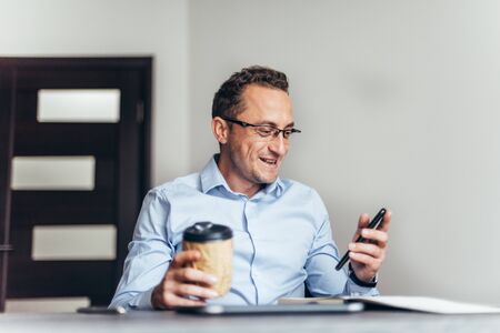 Business is happy after agreed about the successful transaction by phone in officeの写真素材