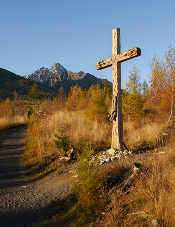 Catholic wooden cross in autumn landscapeの写真素材