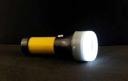 The included flashlight on a black background.の写真素材