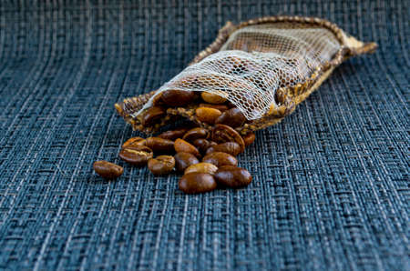 The coffee beans spilled out of the bag and scattered.の写真素材