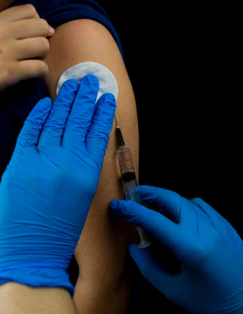 The child is vaccinated in the shoulder.の写真素材