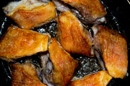Fried perch in a frying pan.の写真素材