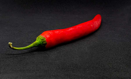 Red hot chili pepper on a black background.の写真素材
