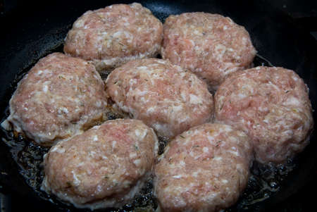 Cutlets are fried in a frying pan with olive oil.の写真素材