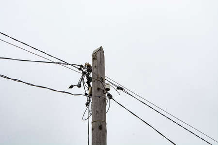 Wooden pole with electrical wiring.