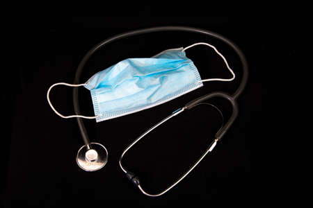 Blue medical disposable mask with stethoscope.の写真素材