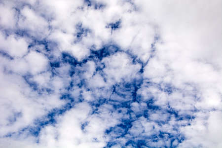 Many small white clouds in the blue sky.