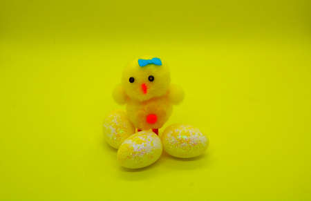 Decorative chicken with small painted eggs.
