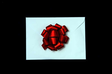 A letter with a red gift bow.