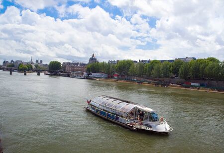The image of a survey on the tour boat on the river Seine along the sights of Paris. France.の写真素材