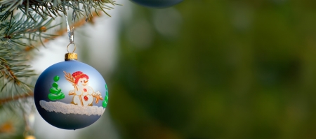 One piece of Christmas decoration of garland, on fir-tree's branch with green background having much copyspace One piece of Christmas decoration of garland, on fir-tree's branch with green background having much copyspace