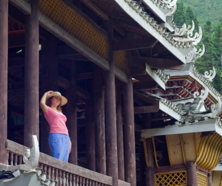 Portrait image of Attractive women on the bridge. Beauty wearing, looking forward to first date. Old bridge architecture on the background.の写真素材